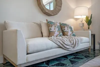 a white couch in a living room with a mirror at Icon Brickell Gem 2-BR Oasis with Amazing Views in Miami