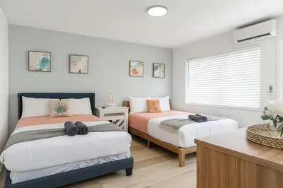 a bedroom with two beds and a window at Dania Beach 1BR | Steps to Ocean + Parking in Dania Beach
