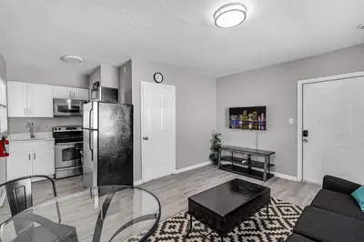 a kitchen and a living room with a glass table at Triplex with 3 Bedrooms, 6 Min/Beach+Free Parking in Dania Beach