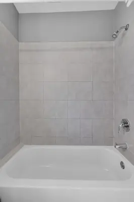 a white bath tub with a faucet in a bathroom at Cozy 1BR Retreat | 6-Min to Beach + Free Parking in Dania Beach