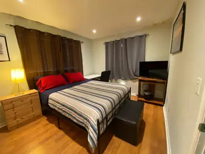 a bedroom with a bed and a dresser and a television at Econoroom Hollywood in Hollywood