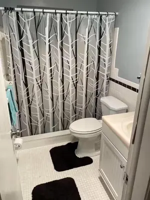 a bathroom with a toilet and a shower curtain at Econoroom Hollywood in Hollywood