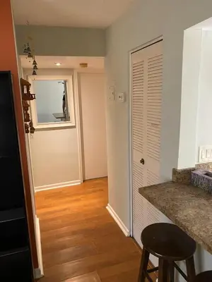 a room with a kitchen with a counter and a door at Econoroom Hollywood in Hollywood
