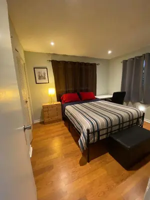 a bedroom with a bed with red pillows at Econoroom Hollywood in Hollywood