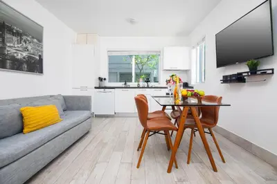 a living room with a couch and a table and chairs at Boutique Apartments SoBe in Miami Beach