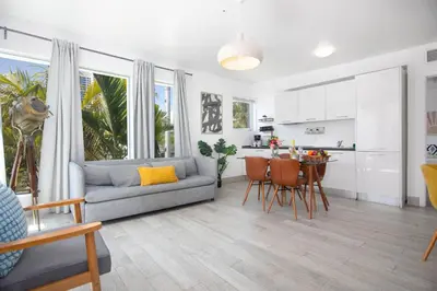 a living room with a couch and a table with chairs at Boutique Apartments SoBe in Miami Beach