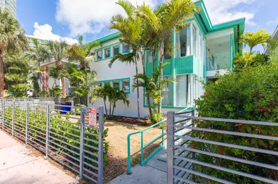 a house with a fence in front of it at Boutique Apartments SoBe in Miami Beach