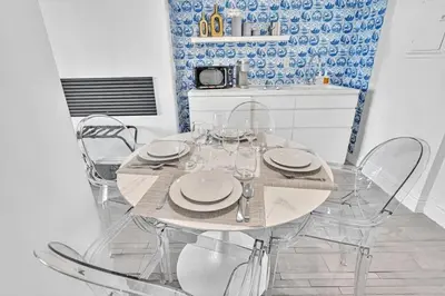 a dining room with a table with chairs and a kitchen at Brand New Mondrian - Miami Beach Waterfront Condo in Miami Beach