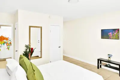 a white room with a bed and a mirror at New Mimo 8 New -Walkable - Smart TV - Nespresso - Free Parking in Miami