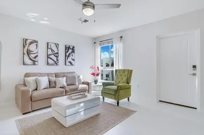 a living room with a couch and a chair at Beachside Bliss, 1BR Condo with Pool at Dania Beach in Dania Beach