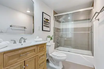 a bathroom with a toilet and a sink and a shower at Beachfront Oasis in Sunny Isles 4BR, Pool & Tennis in Sunny Isles Beach