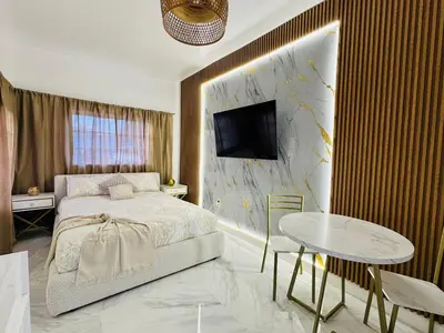 a bedroom with a bed and a table and a tv at Stylish Studio in Heart of Miami in Miami
