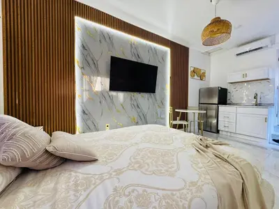 a bedroom with a bed and a tv on a wall at Stylish Studio in Heart of Miami in Miami