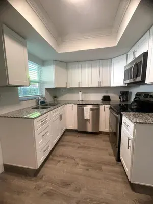 an empty kitchen with white cabinets and appliances at New Apt 2 Bed 2 Bath with Amazing PATIO in Fort Lauderdale