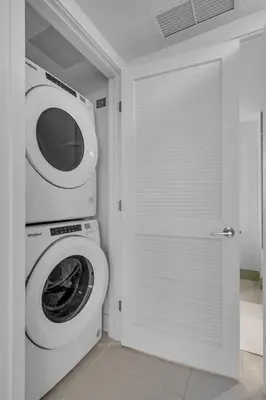 a washer and dryer in a bathroom with a washing machine at Sunlit 1BR Condo In Downtown Miami in Miami