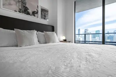a bedroom with a large white bed with a large window at Bright and Breezy 1 Bed Unit With Water and City Views in Miami
