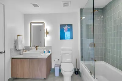 a bathroom with a toilet and a sink and a shower at Bright and Breezy 1 Bed Unit With Water and City Views in Miami