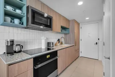 a kitchen with a microwave and a black dishwasher at Bright and Breezy 1 Bed Unit With Water and City Views in Miami