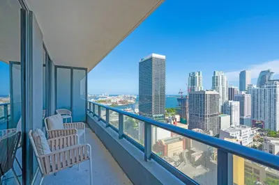 a balcony with two chairs and a view of the city at Bright and Breezy 1 Bed Unit With Water and City Views in Miami
