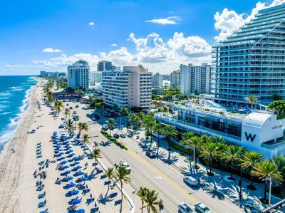 an aerial view of a beach with palm trees and buildings at 23rd Floor W 2BR with Den, Ocean Views, Sleeps 8 in Fort Lauderdale