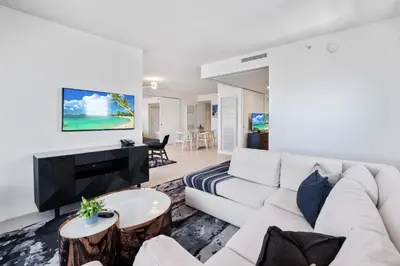 a living room with a white couch and a table at 23rd Floor W 2BR with Den, Ocean Views, Sleeps 8 in Fort Lauderdale