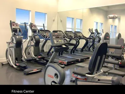 a gym with a bunch of cardio machines at Provident Doral at The Blue in Miami