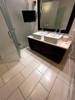 a bathroom with two sinks and a large mirror at Provident Doral at The Blue in Miami