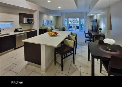 a kitchen and living room with a table and chairs at Provident Doral at The Blue in Miami