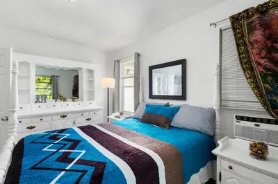 a white bedroom with a large bed and a bathroom at Brickell Stay: Near Beach Downtown Pet-Friendly in Miami