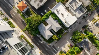 an overhead view of a building with trees and a street at Little Havana 2BR – Near Brickell Midtown in Miami