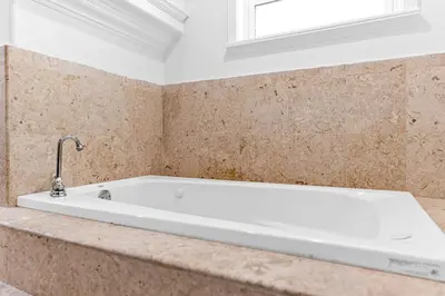 a white bath tub in a bathroom with a window at Stunning Tropical Pool House Miami Coconut Grove in Miami