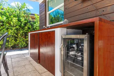 a house with a kitchen with a glass door at Stunning Tropical Pool House Miami Coconut Grove in Miami