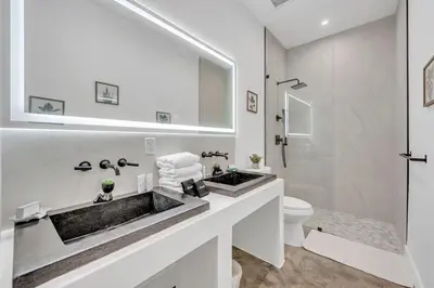a white bathroom with a sink and a toilet at Wonderful New Tropical Pool House North Miami in Gold Coast Heliport