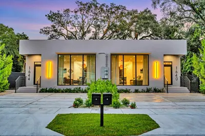 a white house with a sign in front of it at Stunning Tropical Pool House North Miami in Gold Coast Heliport