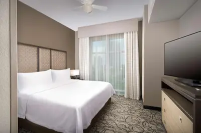 a hotel room with a bed and a flat screen tv at Homewood Suites by Hilton Miami Downtown/Brickell in Miami