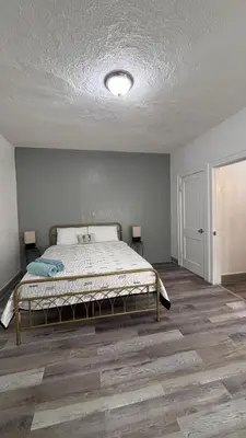 a bedroom with a bed and two lamps in it at Noemi's Studio Suite Steps To Marlins Stadium At Little Havana in Miami