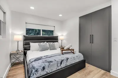 a bedroom with a large bed with a black headboard at Modern & Cozy Private Pool Home in Parkway Regional Medical Center Heliport