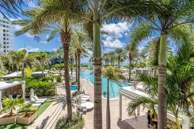 a view of the pool at a resort with palm trees at FontaineBleau Suite at Miami Beach in Miami Beach