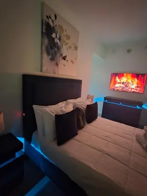 a bedroom with a large bed with blue lights at Miami-Brickell Luxury 2BR-2BATH with skyline VIEWS - walking distance to KASEYA-HEAT ARENA & BAYSIDE - Port of MIAMI cruise ships in Miami