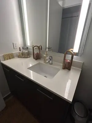 a bathroom counter with a sink and a mirror at Miami-Brickell Luxury 2BR-2BATH with skyline VIEWS - walking distance to KASEYA-HEAT ARENA & BAYSIDE - Port of MIAMI cruise ships in Miami