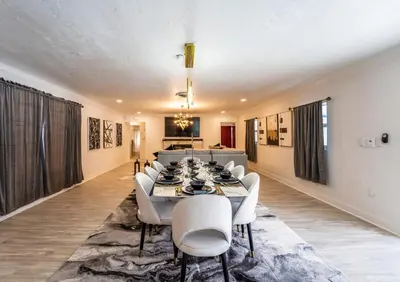 a dining room with a table and white chairs at Top Villa Near Beach with Game Room, Hot Tub and Pool in Pembroke Pines