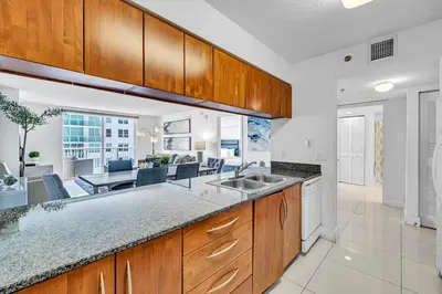 a kitchen with a sink and a living room at Spacious 1 Bed 1 BTH Brickell Ocean View in Miami