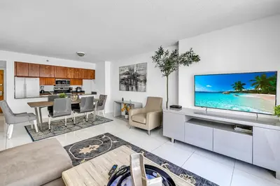 a living room with a large flat screen tv on a wall at Spacious 1 Bed 1 BTH Brickell Ocean View in Miami