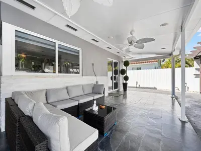 a living room with a couch and a ceiling fan at The Chill Sunny Casa Near Beaches in Miami Lakes