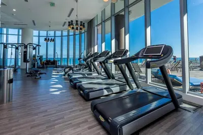 a gym with a row of treadmills at Oceanfront Retreat Scenic Views & Coastal Comfort in Hollywood