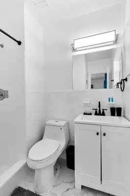 a white bathroom with a toilet and a sink at Relax & Fun Hollywood Private Pool | Arcade Game in Hollywood