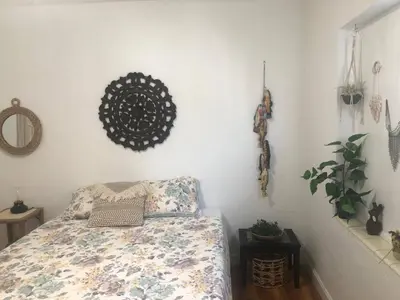 a bedroom with a bed and a plant and a mirror at 2 Bedroom Apartment Free Reserved Parking in Miami