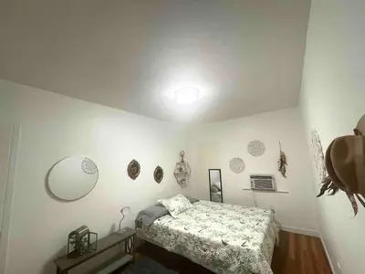 a bedroom with a bed in a room with white walls at 2 Bedroom Apartment Free Reserved Parking in Miami