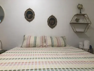 a bed with two pillows and two mirrors on the wall at 2 Bedroom Apartment Free Reserved Parking in Miami