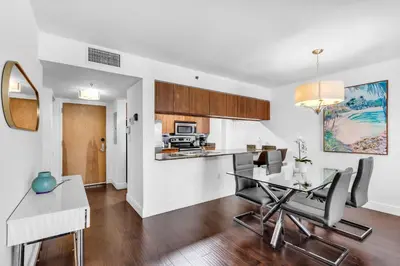 a kitchen and dining room with a table and chairs at Relaxing 1-Bed Condo With City Views in Brickell Key in Miami